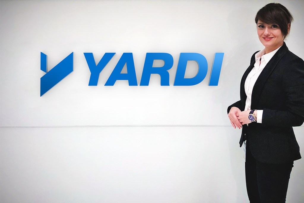 Parisa Vafaei next to Yardi sign