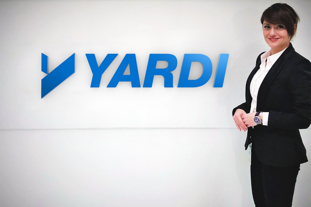 Parisa Vafaei next to Yardi sign